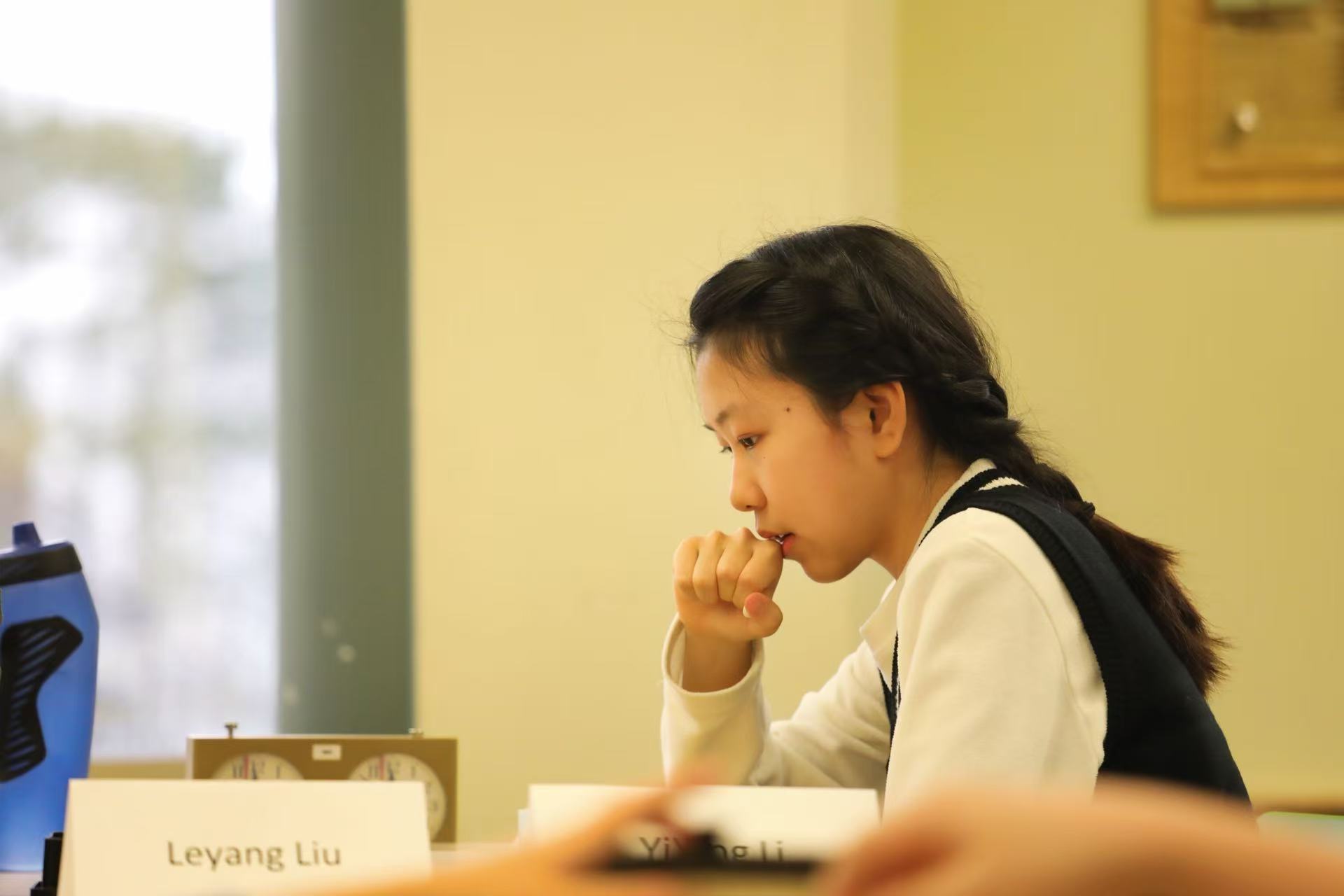 Students playing Go in a bright classroom