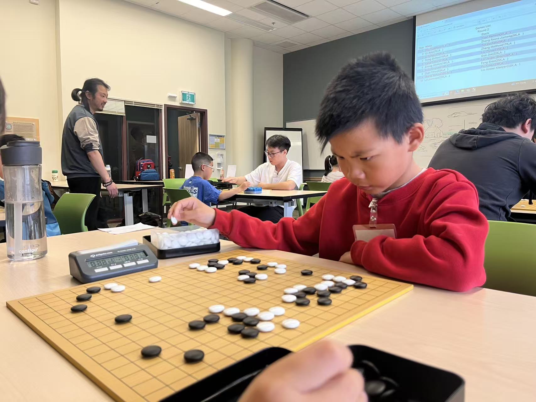 Student playing Go in competition